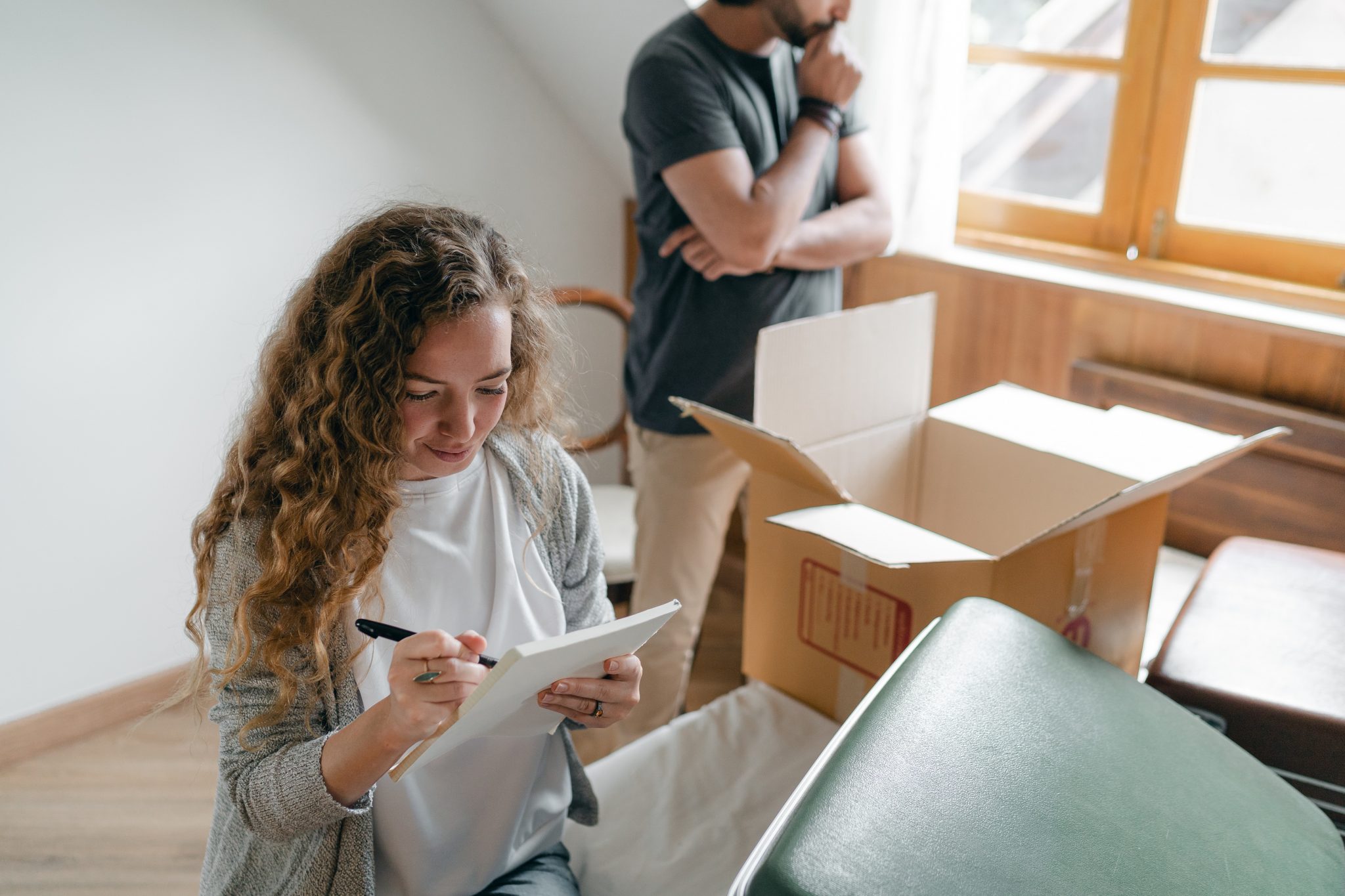 man and woman packing their belongings and moving out of their house